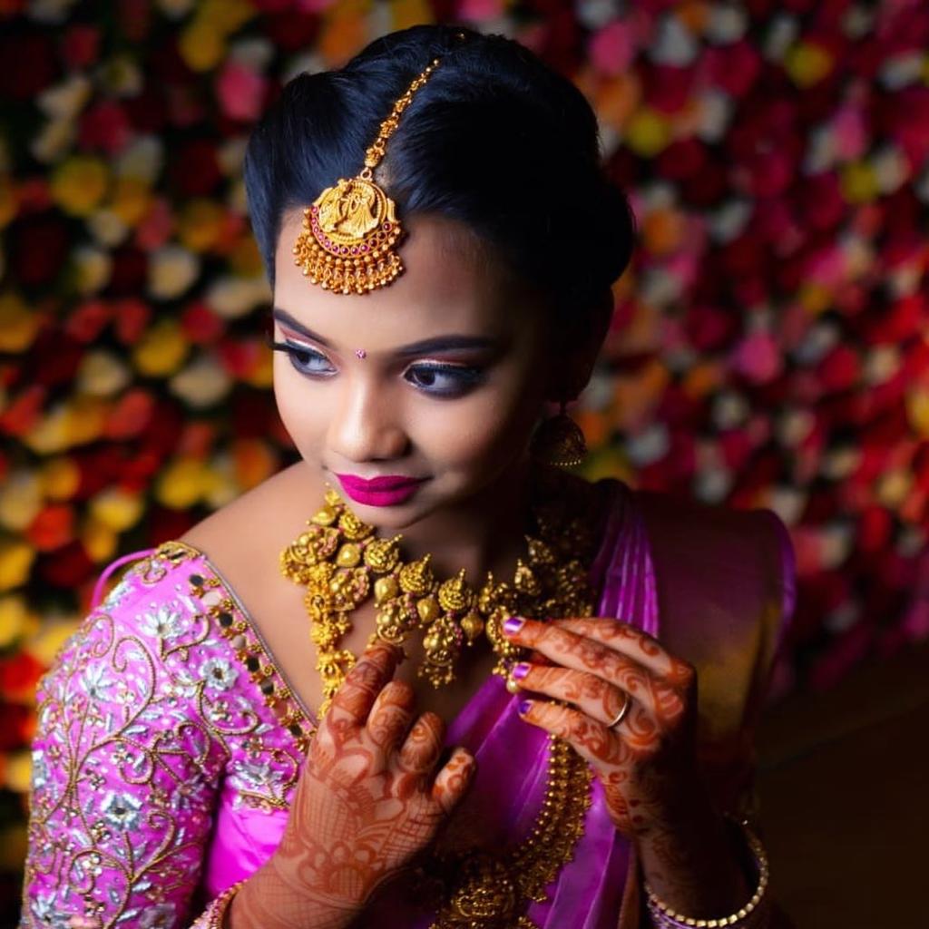 A Freshh bride after a full bridal sitting — gold jewellery, mehendi, peony-pink silk